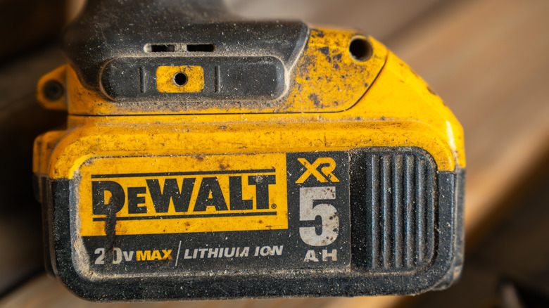 A dirty and old DeWalt power tool bttery