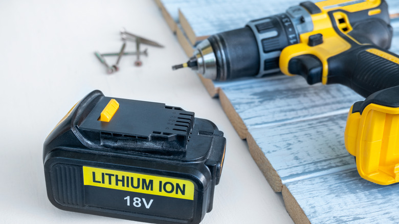 An image of  a 18 volt recharge lithium-ion battery for next to a yellow and black cordless drill