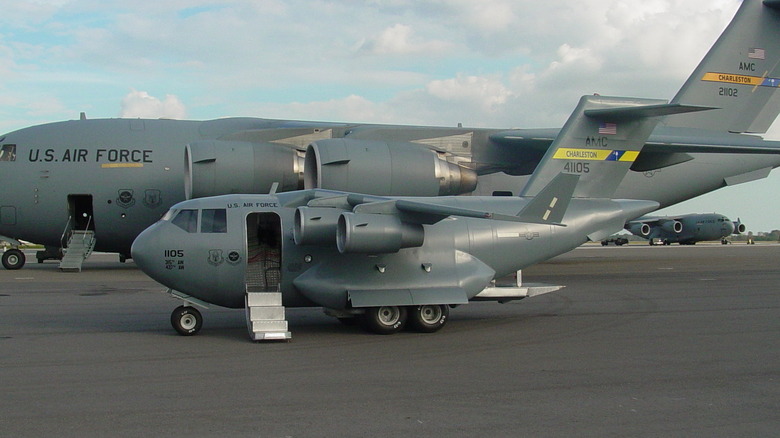 the mini C-17 model stands next to a real C-17 Globemaster