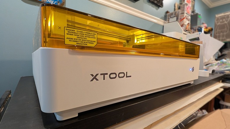 xTool M2 laser cutter and printer machine on a desk.