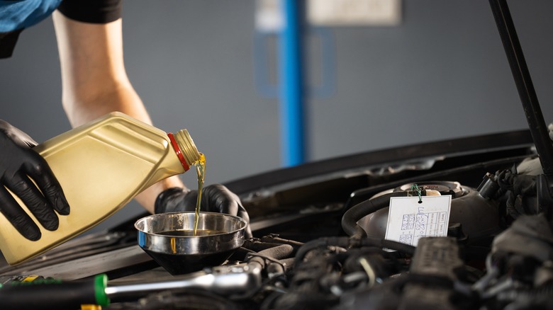 Motor oil being poured by mechanic