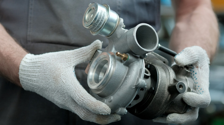 Mechanic holding  a new turbo