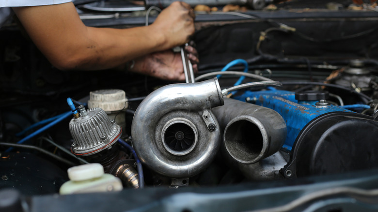 Mechanic working on turbocharged engine