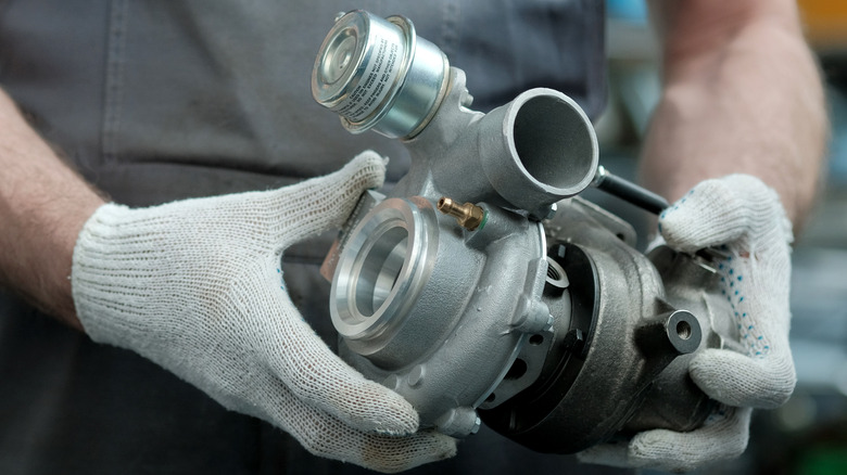 Mechanic holding  a new turbo