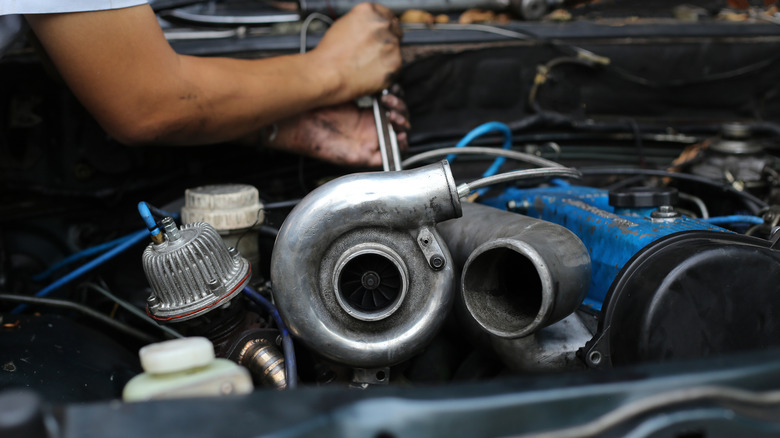 Mechanic working on turbocharged engine