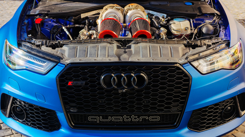 Audi Quattro with hood open showing a twin turbo engine
