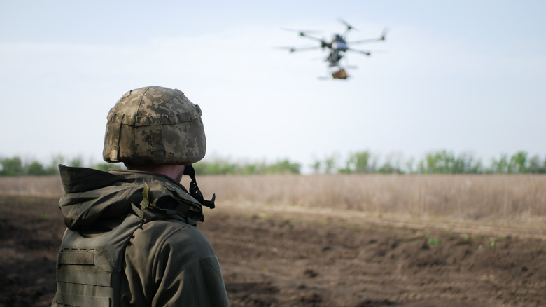 Soldier watches drone in flight.