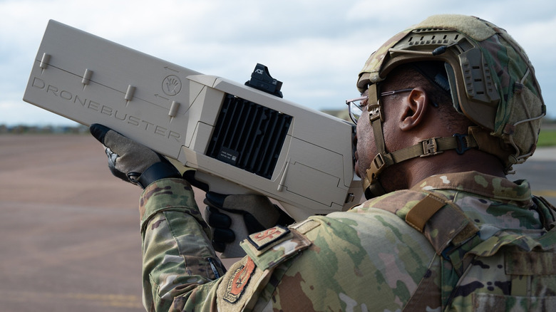 Soldier aiming Dronebuster weapon.