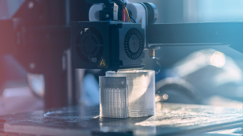 A 3D printer printing an unidentifiable object using clear filament