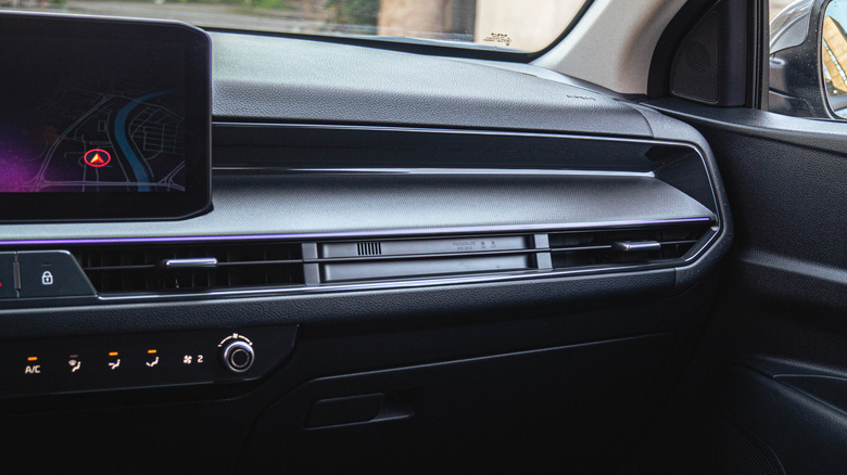 The passenger side of the dashboard inside a Kia Stonic, showing climate controls and climate vents