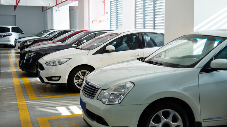 Cars parked in a packed garage