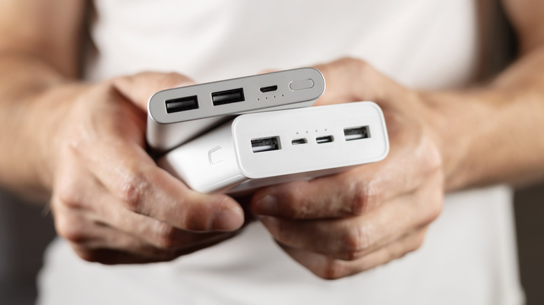 Two power banks in hand