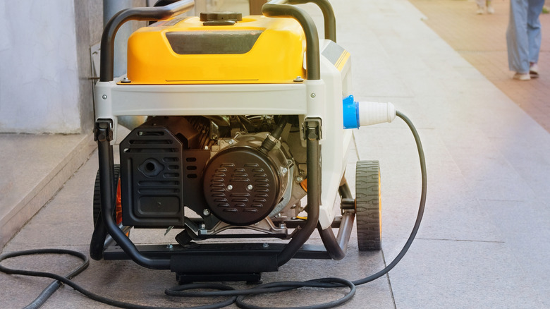 Yellow generator with cable plugged in