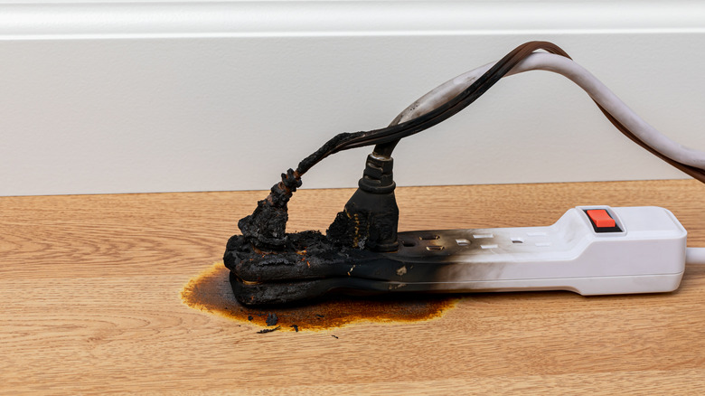 Burned extension cord with cables plugged in