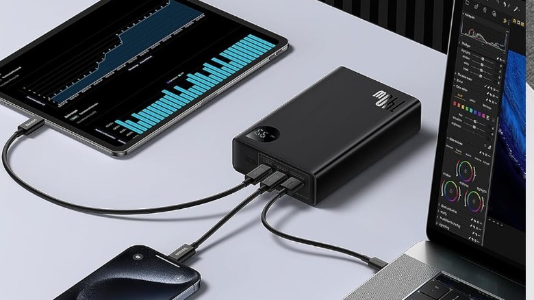 Baseus 140W Portable Charger connected to laptop, tablet and phone