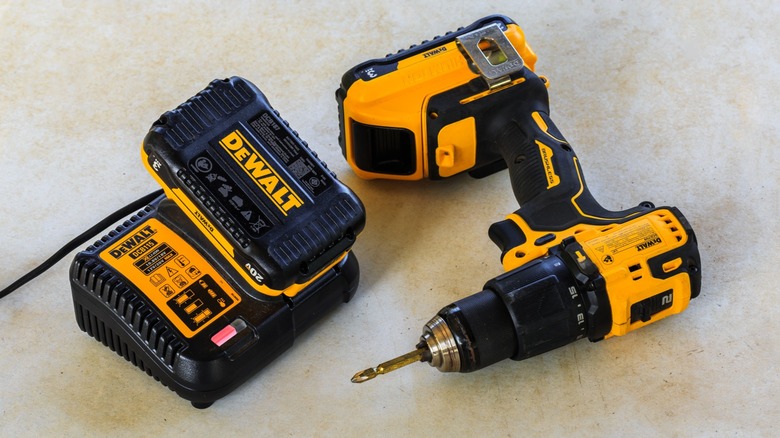 A DeWalt cordless drill alongside a 20V battery and charger.