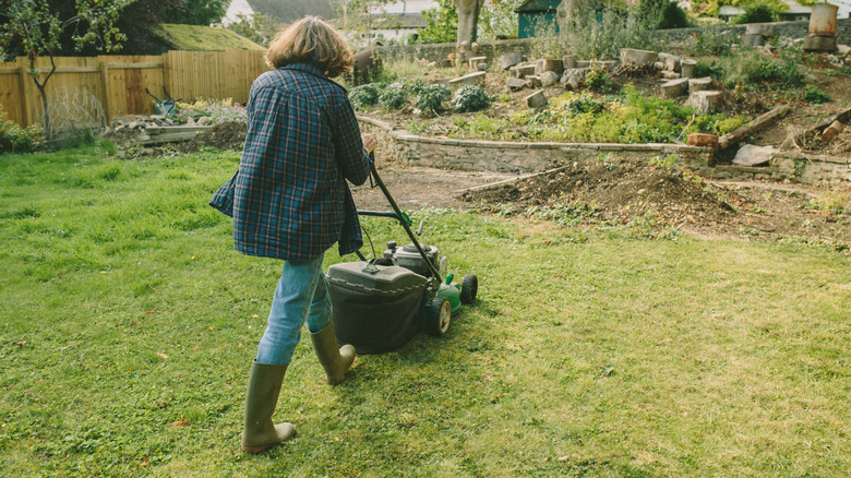 Woman mowing lawn