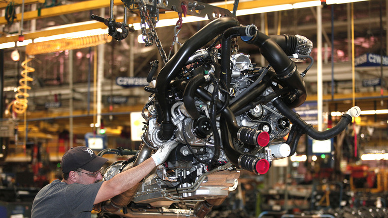 Worker installs Ford EcoBoost engine at Ford factory