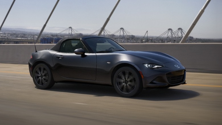 mazda miata driving on bridge
