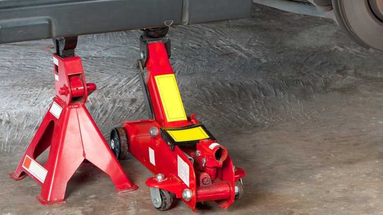 floor jack with jack stand under vehicle