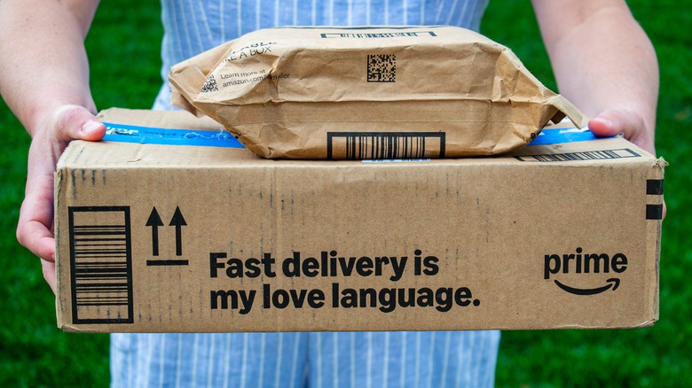 Person holding two Amazon packages