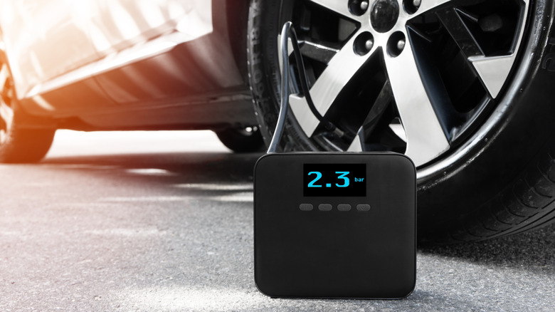 A portable tire inflator filling a tire.