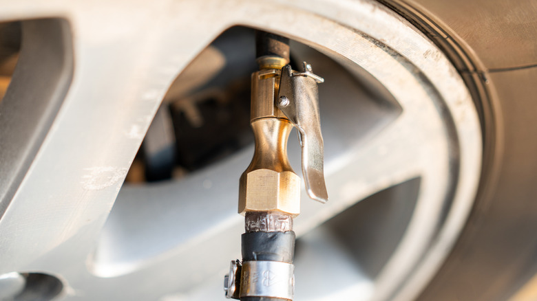 A tire air pump nozzle in a tire.