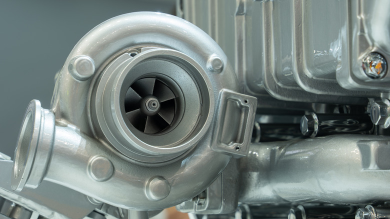 Close up of a new diesel engine with a turbocharger on it.
