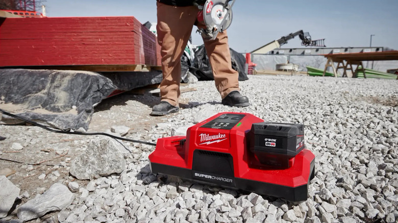 A Milwaukee M18 Super Charger plugged in on the ground.