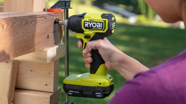 Person using Ryobi drill