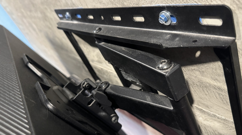 full-motion TV wall mount in concrete wall