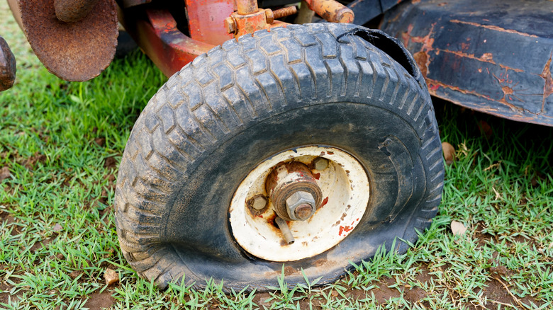 Flat tire of vintage riding lawn mower