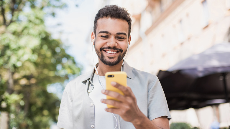 person holding phone smiling