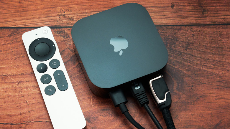 Apple TV next to remote with cables plugged in