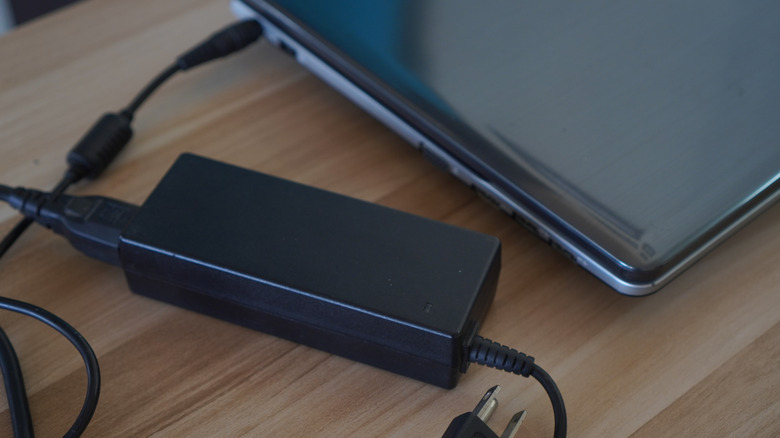 Laptop connected to brick and power cord