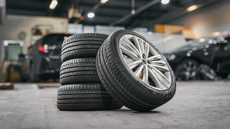 Sety of automobile tires sitting on a garage floor