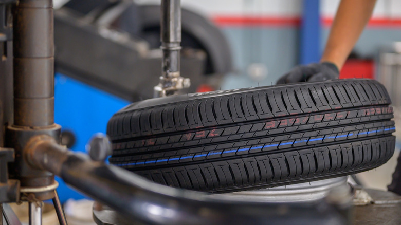 A new car tire being fitted
