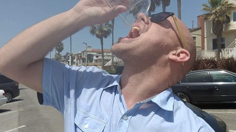 man drinking water from toyota mirai