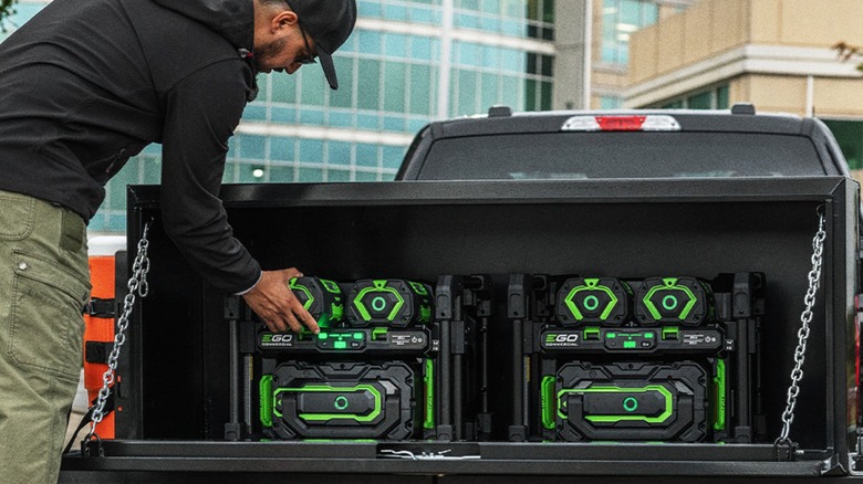 Man loading EGO power bank into vehicle