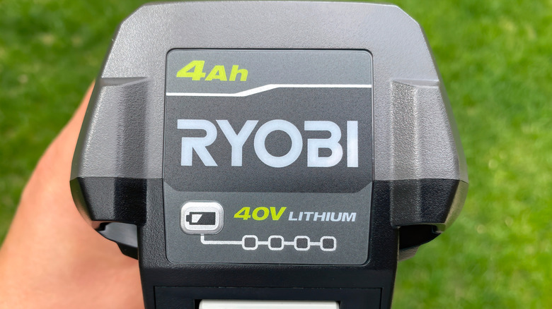 A close up of Ryobi 40V in front of grass