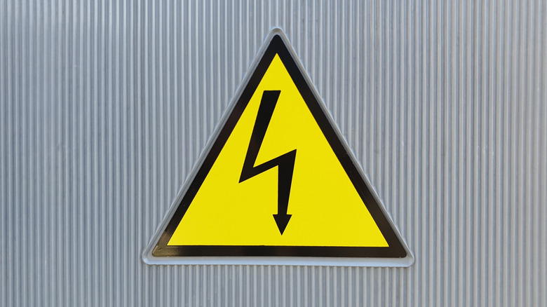 Hugh voltage warning sign on steel wall