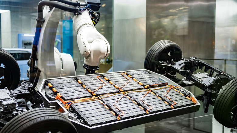 Robotic arm working on EV battery