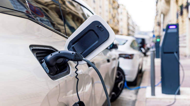 Electric vehicles being charged by sidewalk