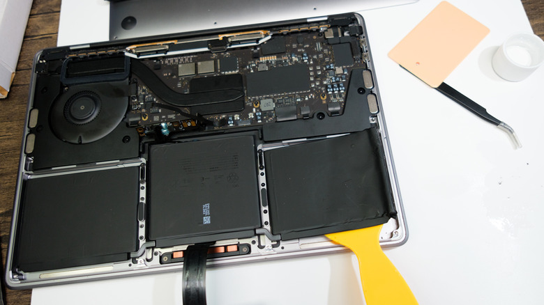 MacBook with back opened and showing separate batteries