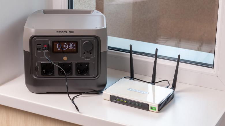 EcoFlow portable power station powering a router beside it