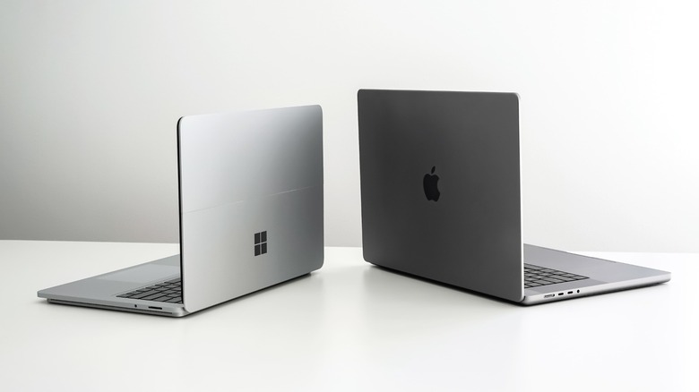 A Microsoft and Apple laptop side by side
