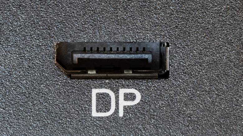 A close-up of a DisplayPort connection port with the letters DP under it