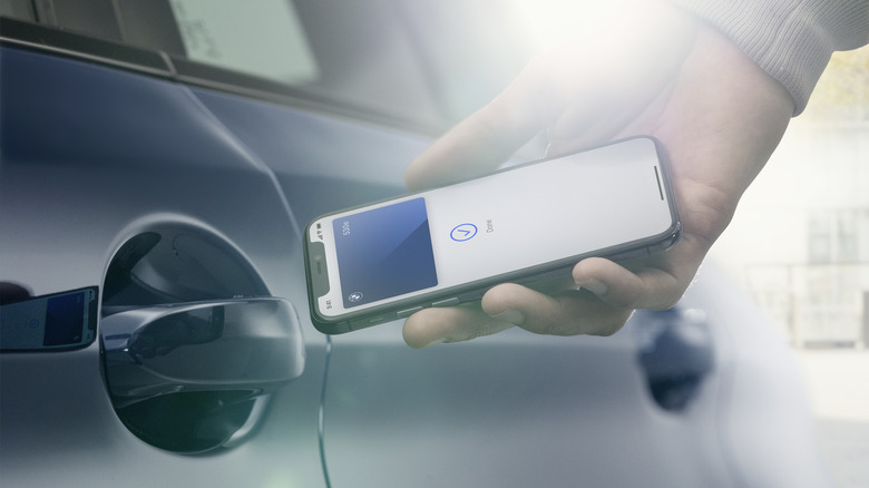 An iPhone unlocking a BMW car door using a BMW Digital Key