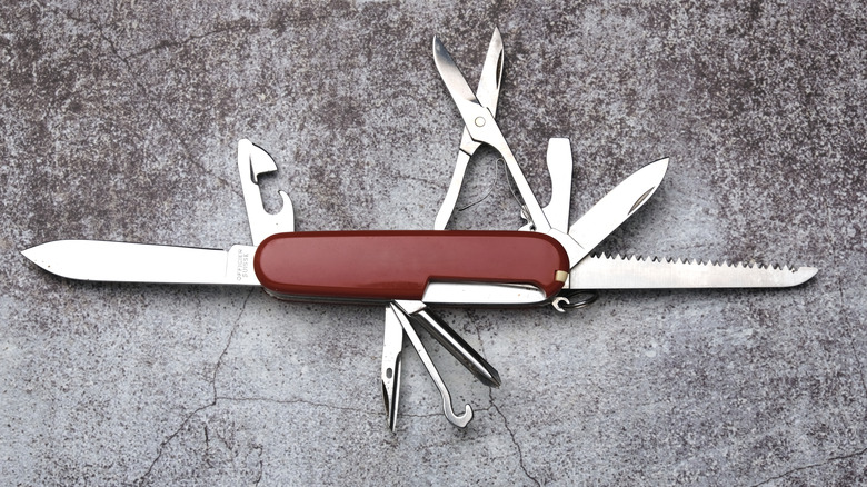 Open multi-tool with a serrated blade on one end