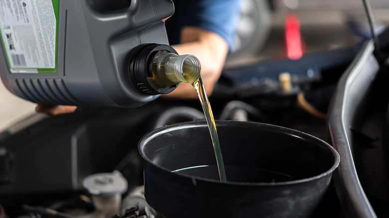 engine oil being poured into the engine